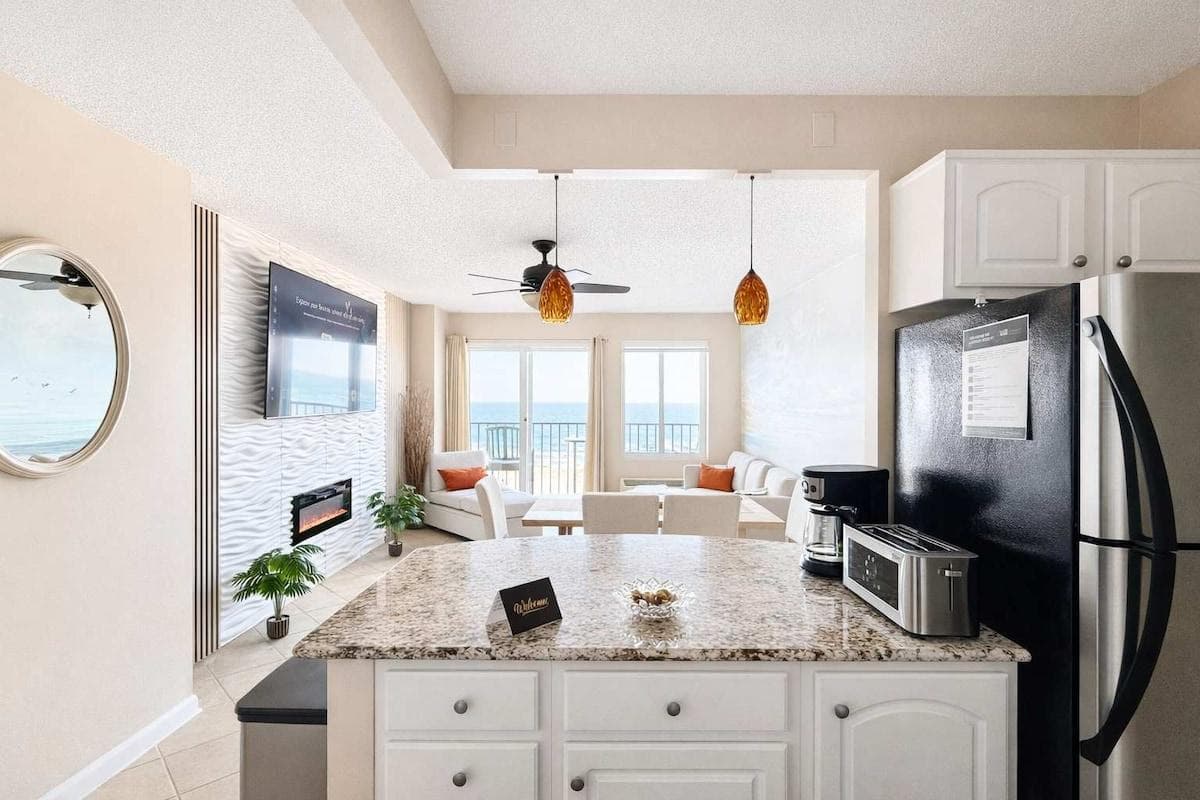 Open-View Kitchen Fully Equipped with all cookware and utensils you need for a seamless vacation—full‑size refrigerator, range and stove, microwave, complete cookware and utensils, coffee maker, and toaster.